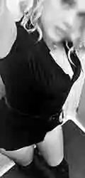 Black-and-white selfie of person in dark outfit