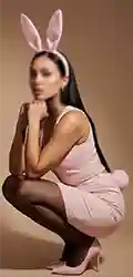 Woman posing in pink bunny costume and heels