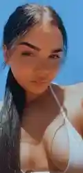 Close-up outdoor selfie of woman in white swimwear